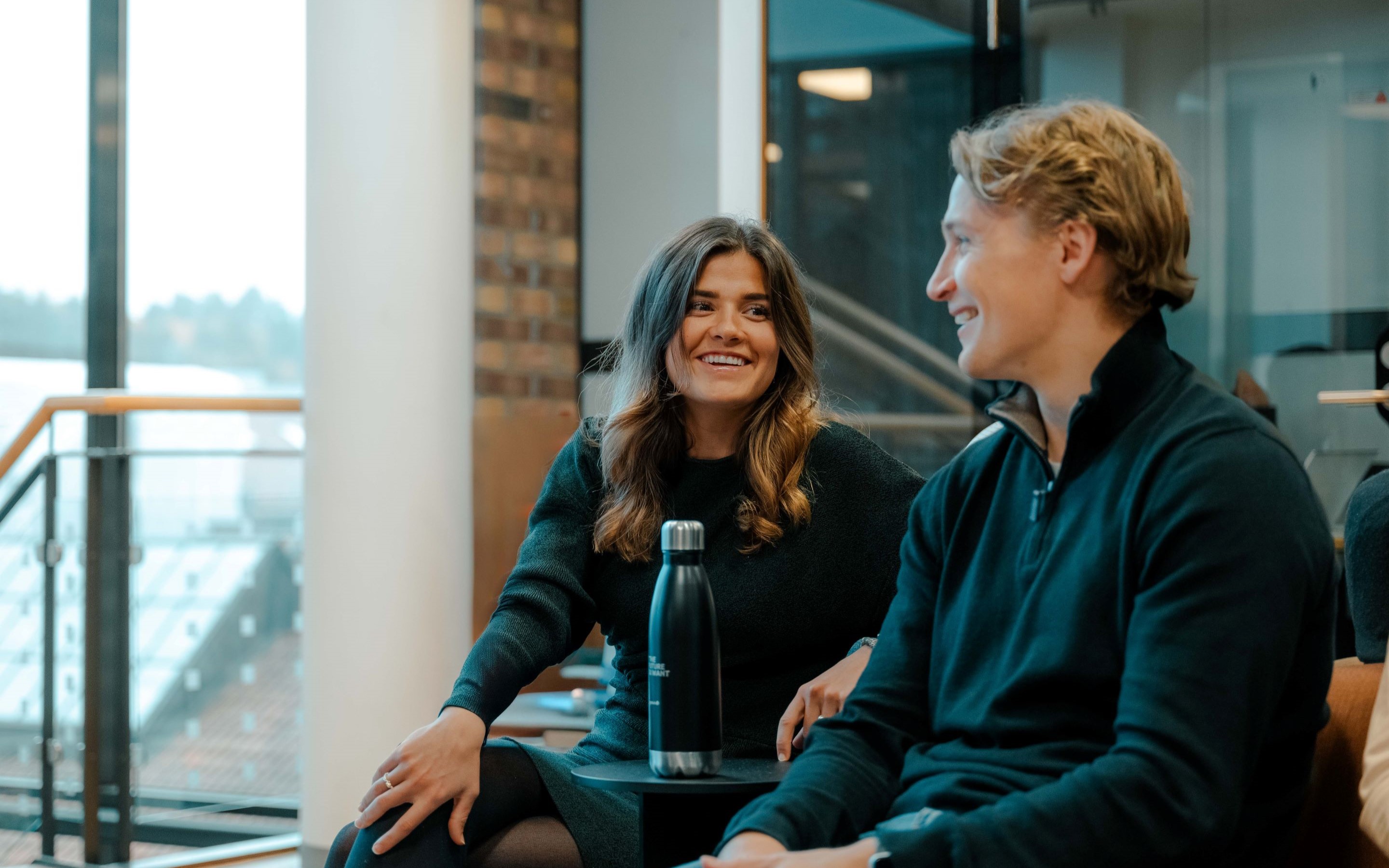Two young colleagues are talking
