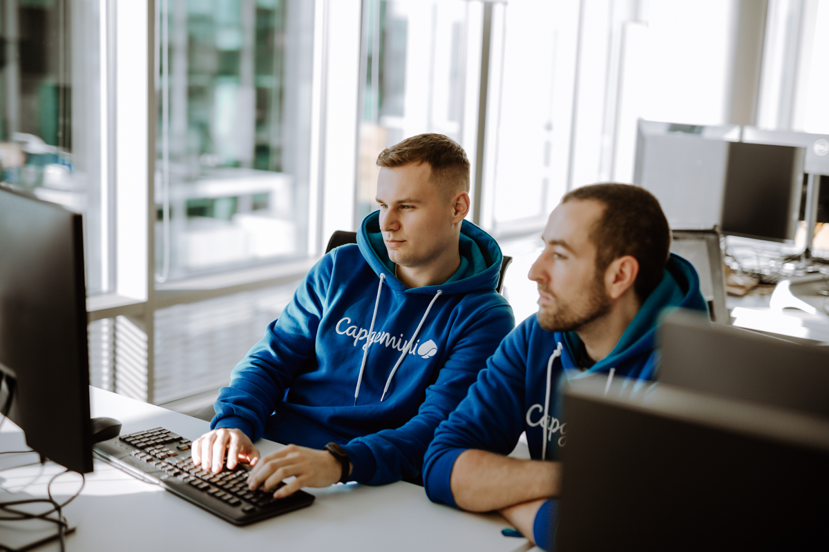 two young men working on the laptop