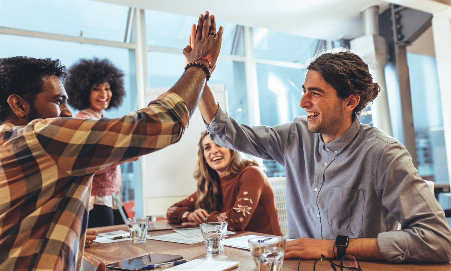 high five colleagues at work