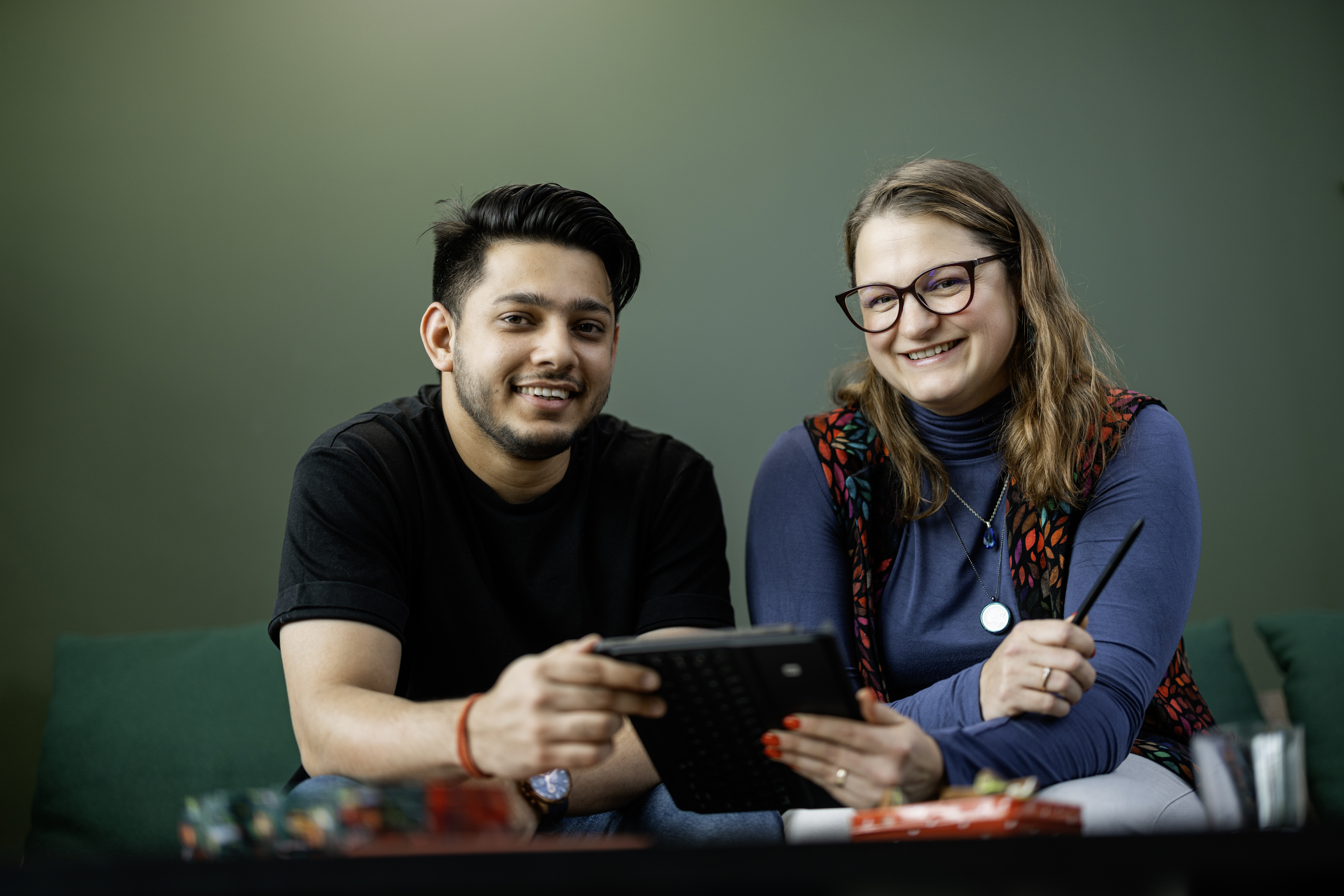 a couple of young people smiling in front of the camera